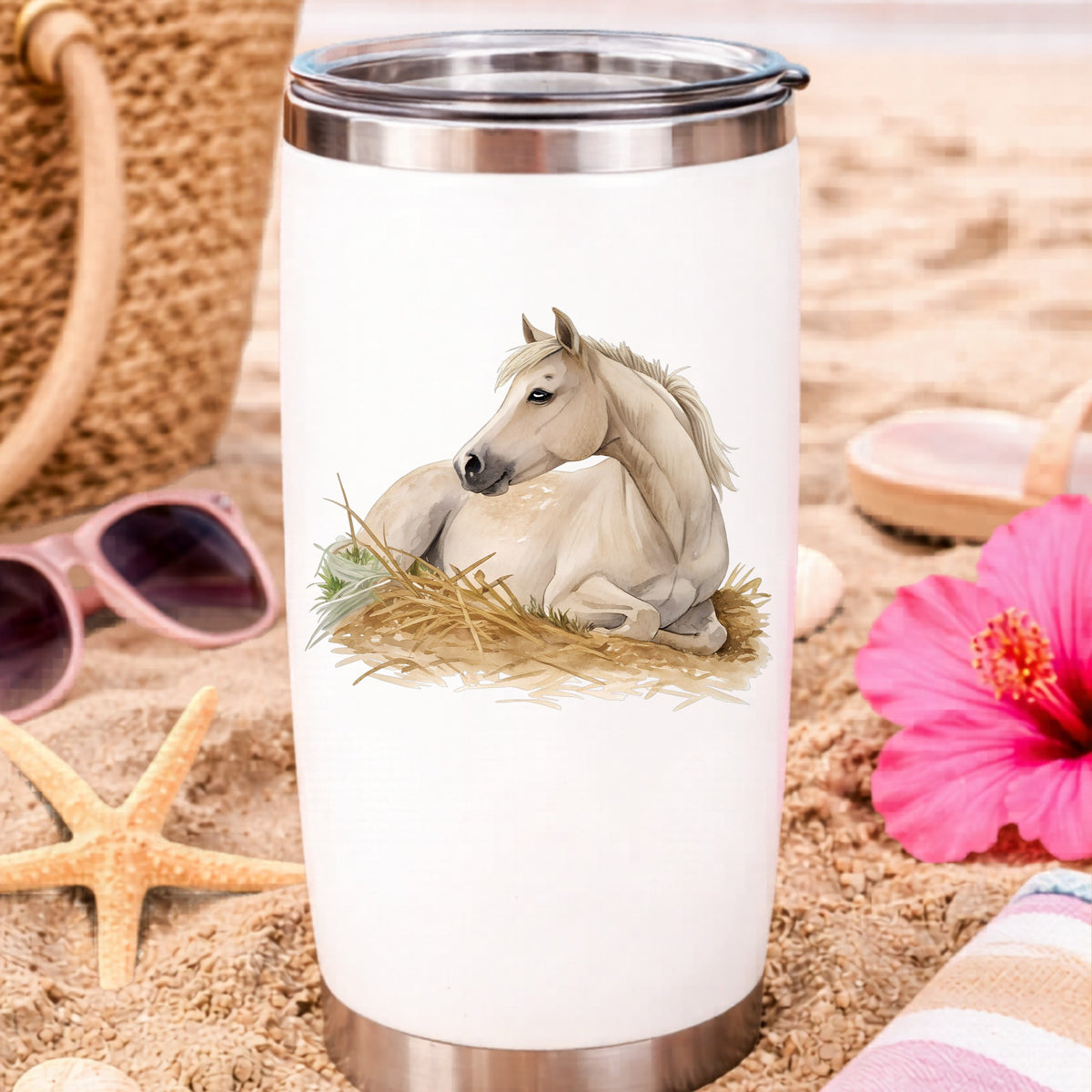 Cream Horse Resting In Hay UV DTF sticker applied to a white travel tumbler on beach sand
