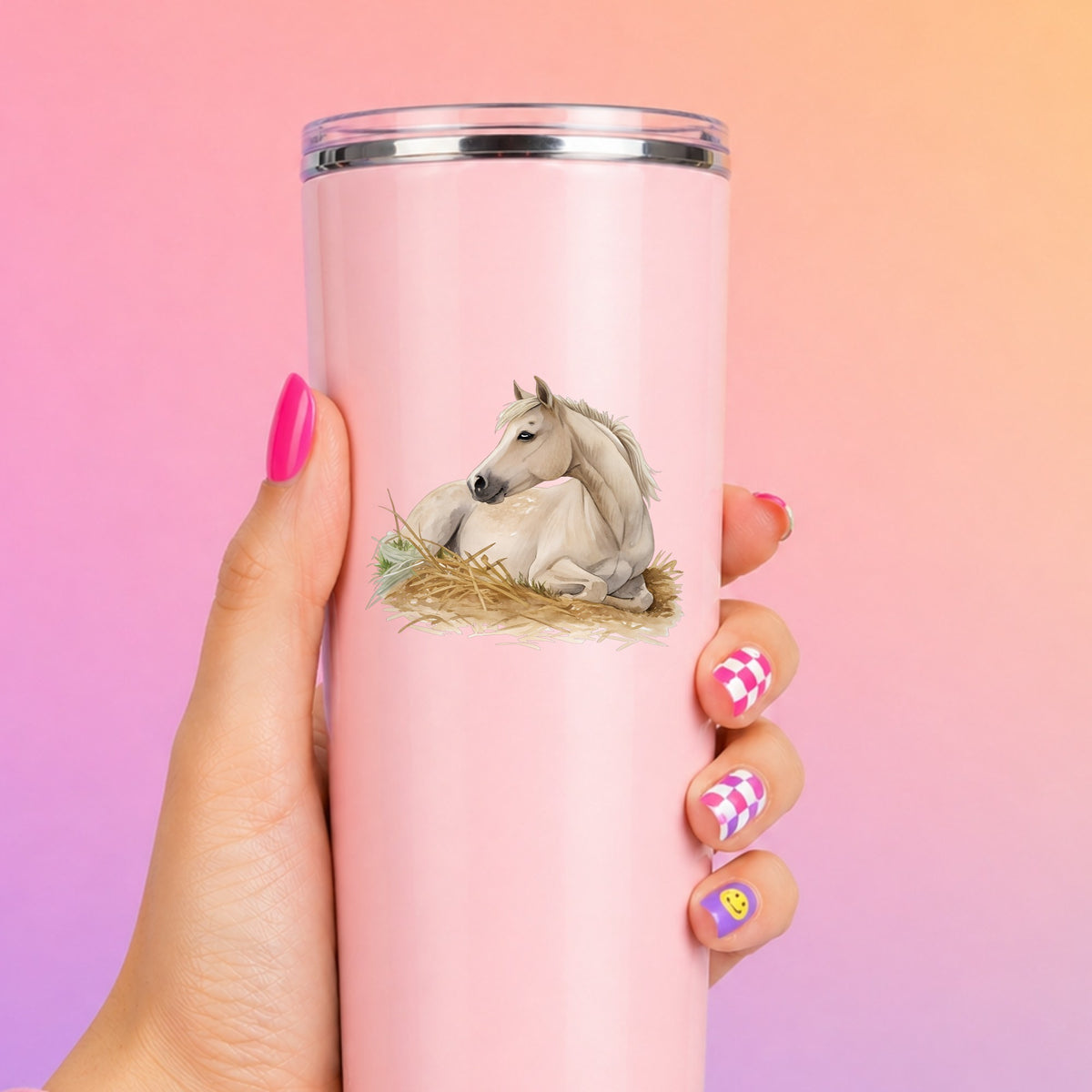 Cream Horse Resting In Hay UV DTF sticker applied to a tall pink tumbler on a pink and orange background