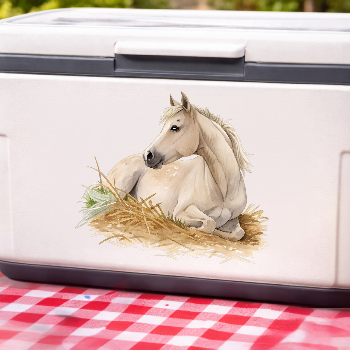Cream Horse Resting In Hay UV DTF sticker applied to a white cooler on a red gingham cloth