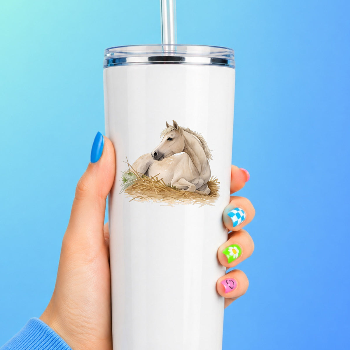 Cream Horse Resting In Hay UV DTF sticker applied to a white straw tumbler on a blue background