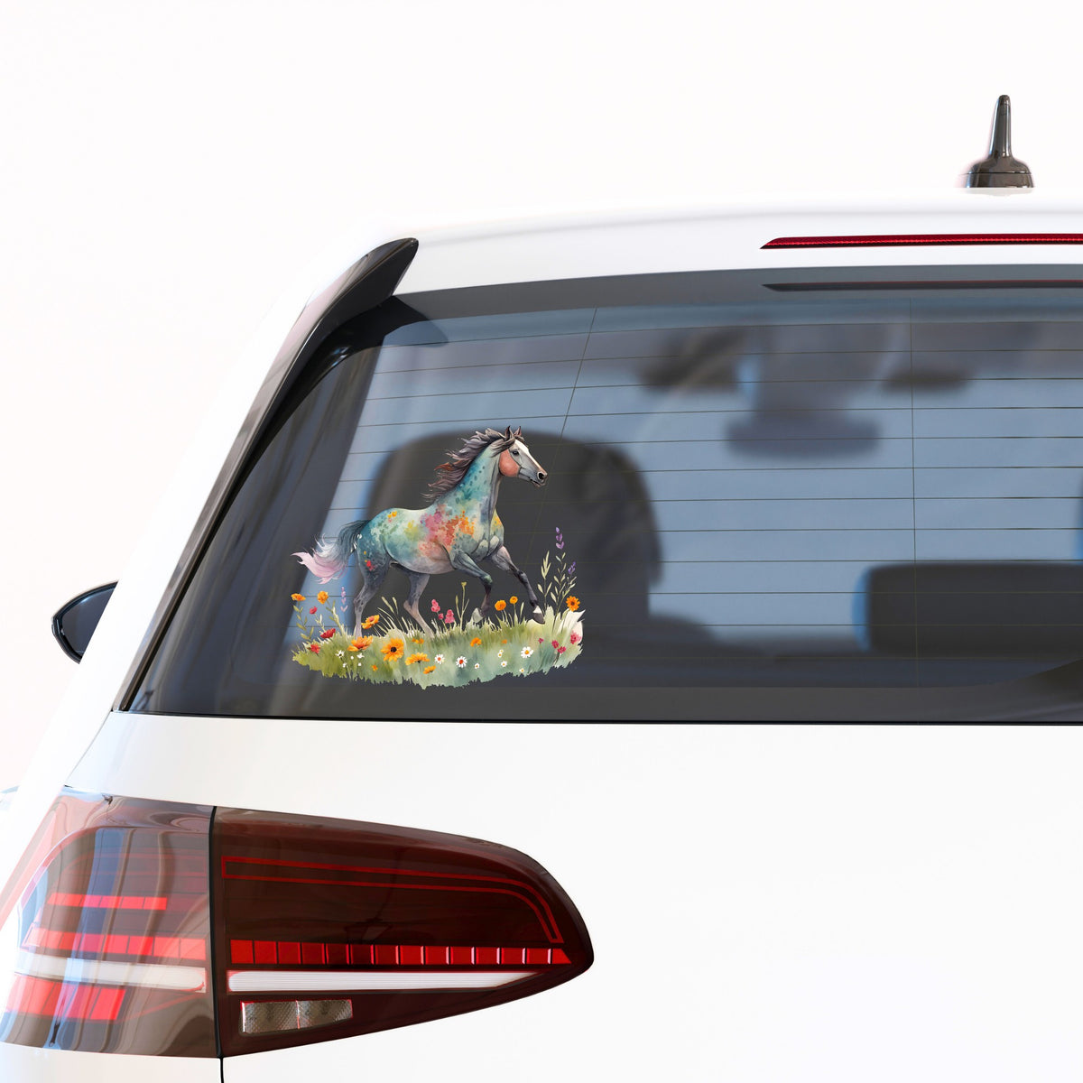 Floral Horse Running Through Wildflowers UV DTF sticker applied to the rear window of a white car