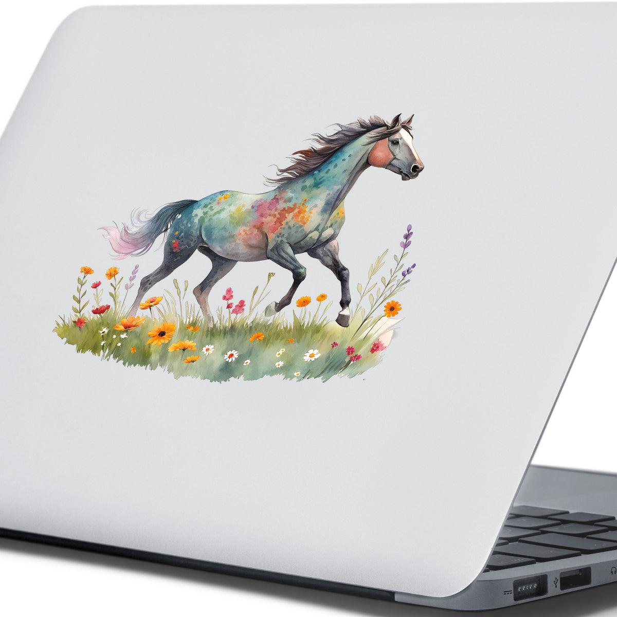 Floral Horse Running Through Wildflowers UV DTF sticker applied to the lid of a silver laptop