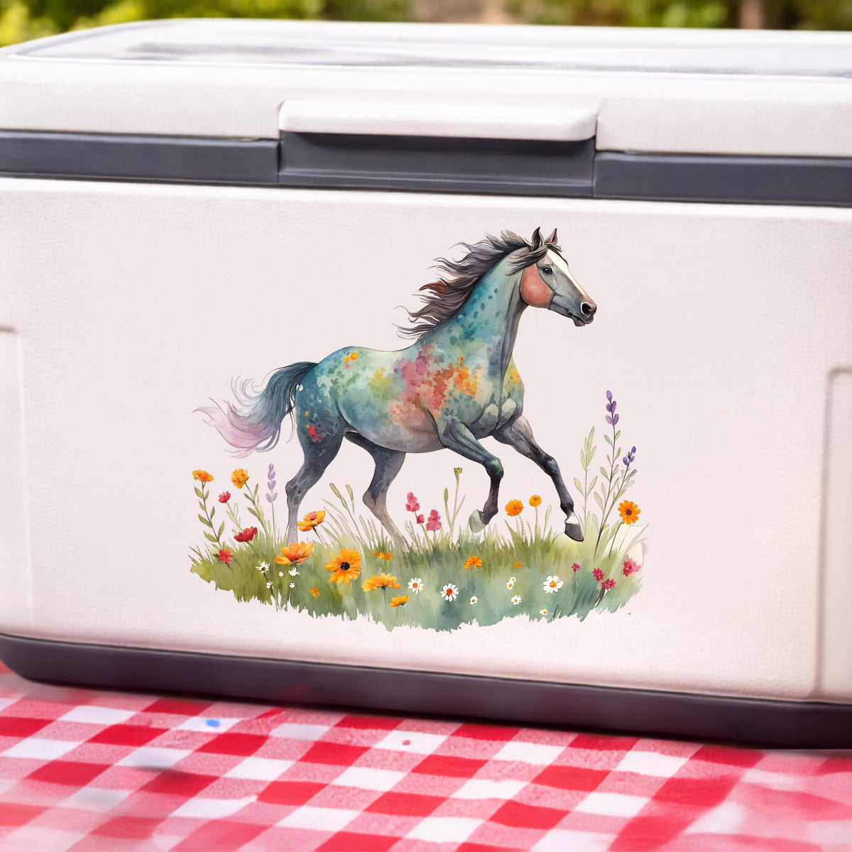 Floral Horse Running Through Wildflowers UV DTF sticker applied to a white cooler on a red gingham cloth