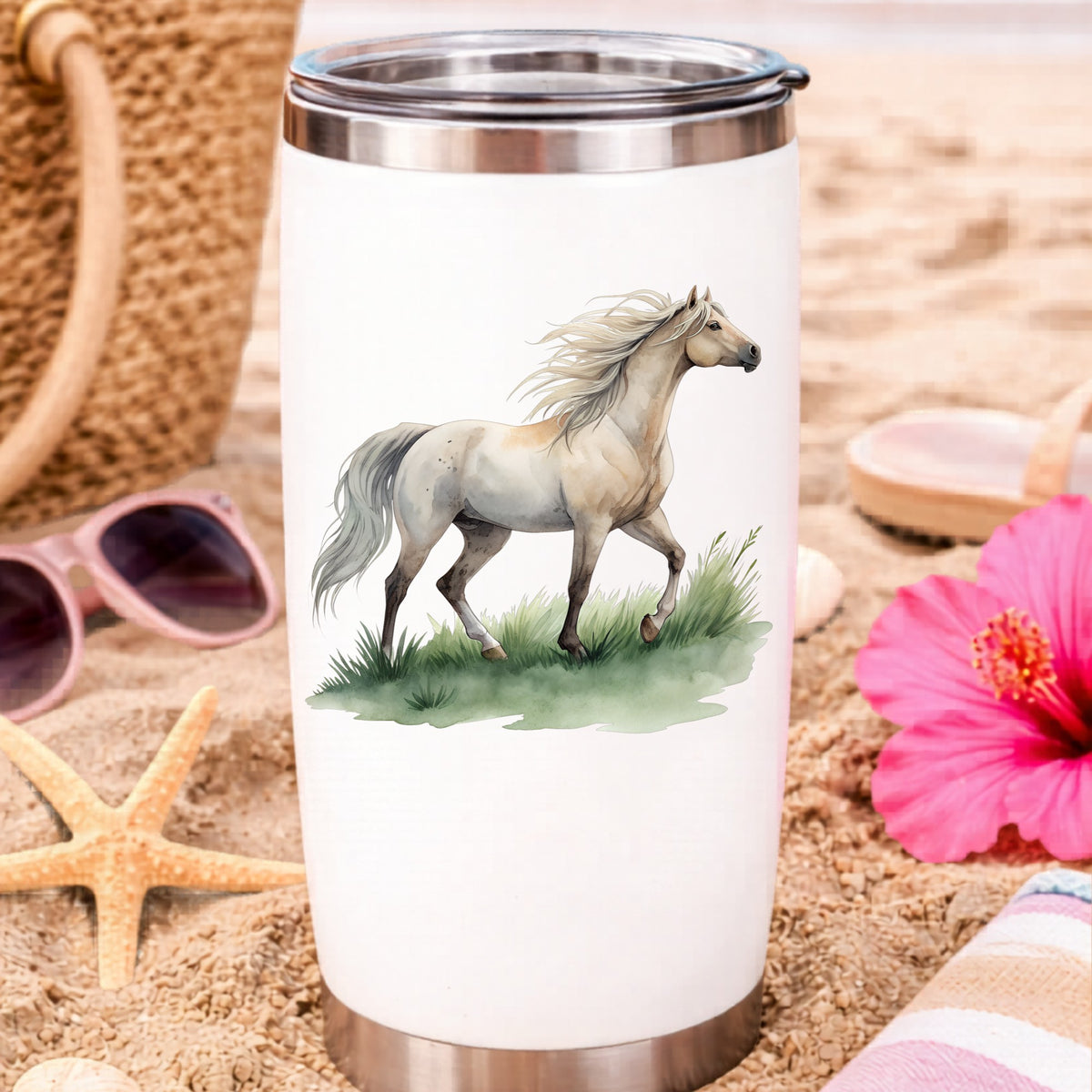 Cream Horse Trotting On Grass UV DTF sticker applied to a white travel tumbler on beach sand