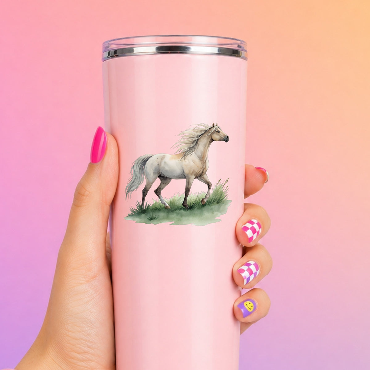Cream Horse Trotting On Grass UV DTF sticker applied to a tall pink tumbler on a pink and orange background