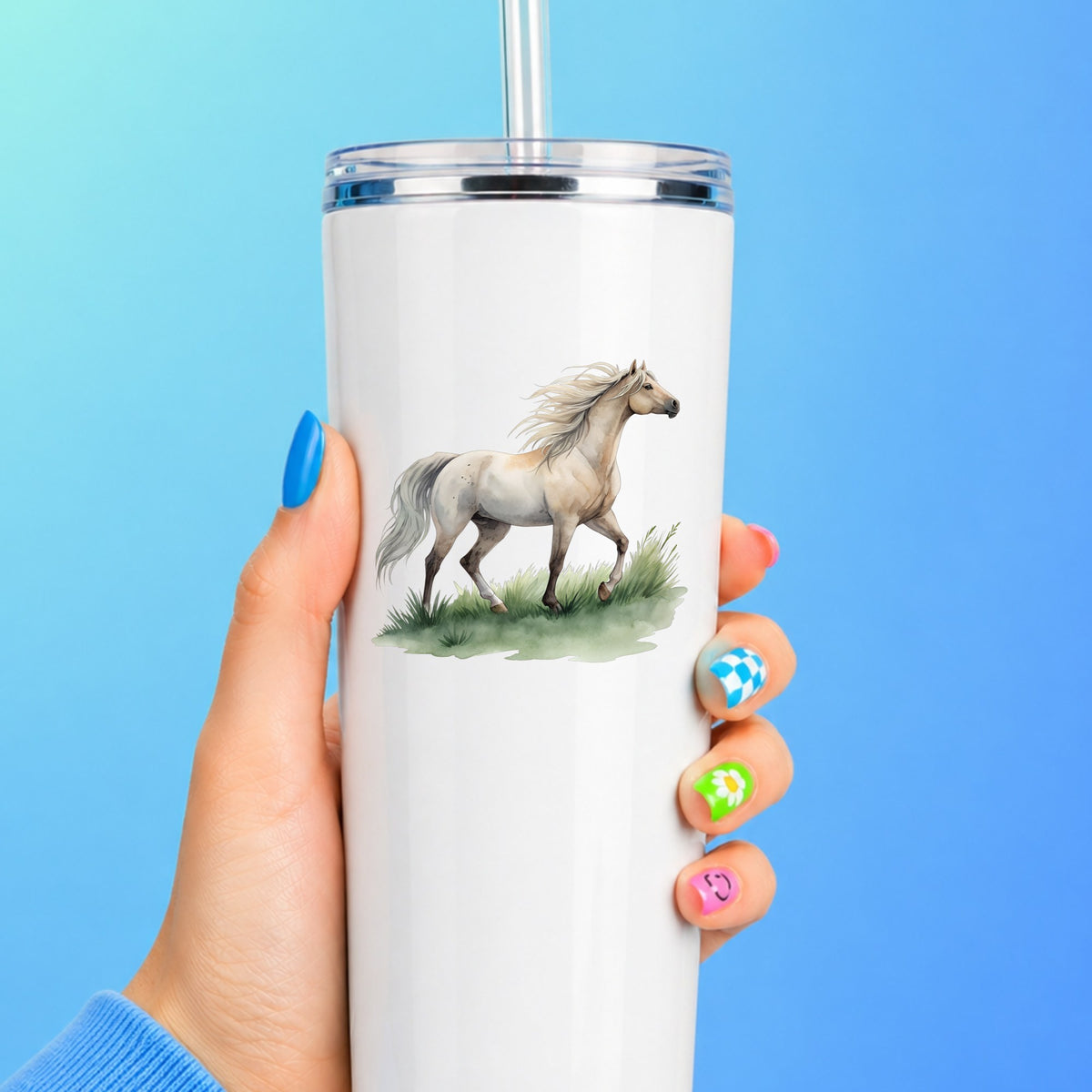 Cream Horse Trotting On Grass UV DTF sticker applied to a white straw tumbler on a blue background