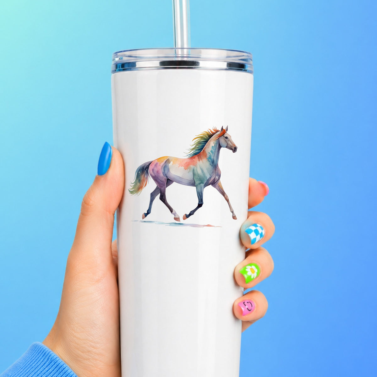Rainbow Mane Horse Trotting UV DTF sticker applied to a white straw tumbler on a blue background