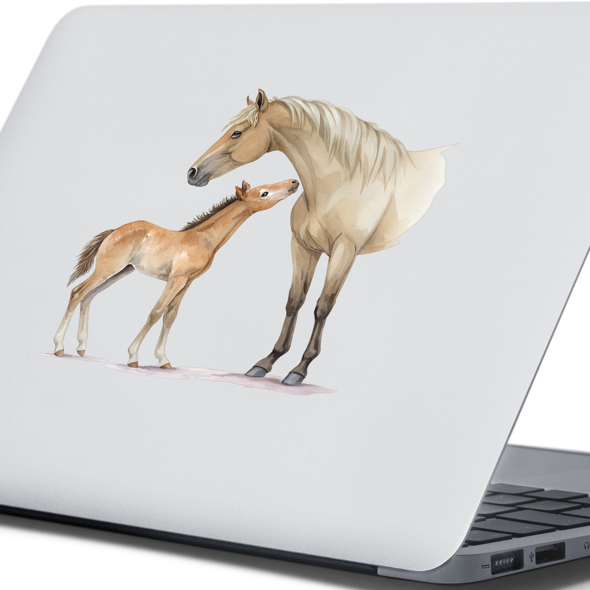 Mare Nuzzling Foal UV DTF sticker applied to the lid of a silver laptop