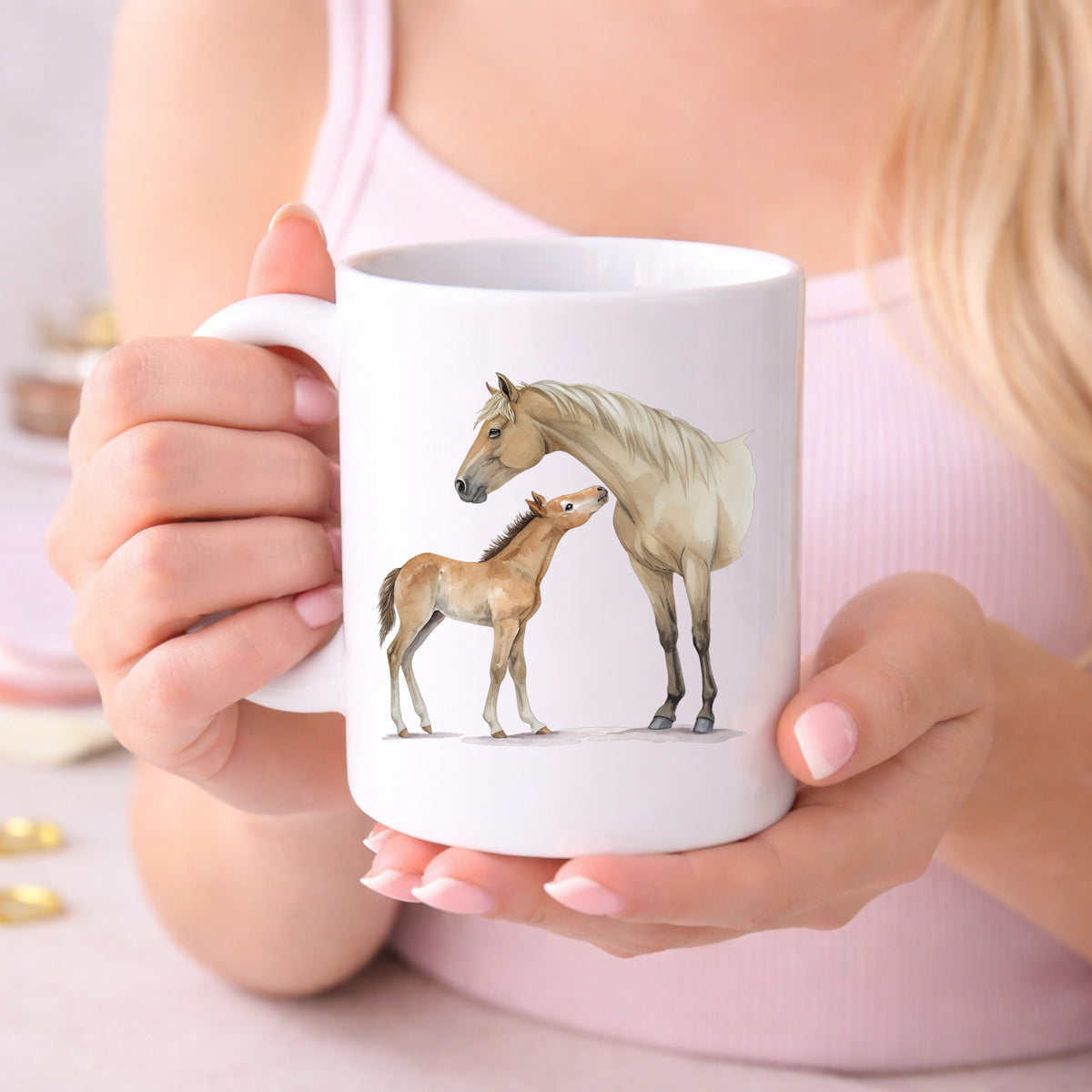 Mare Nuzzling Foal UV DTF sticker applied to a white coffee mug held in both hands