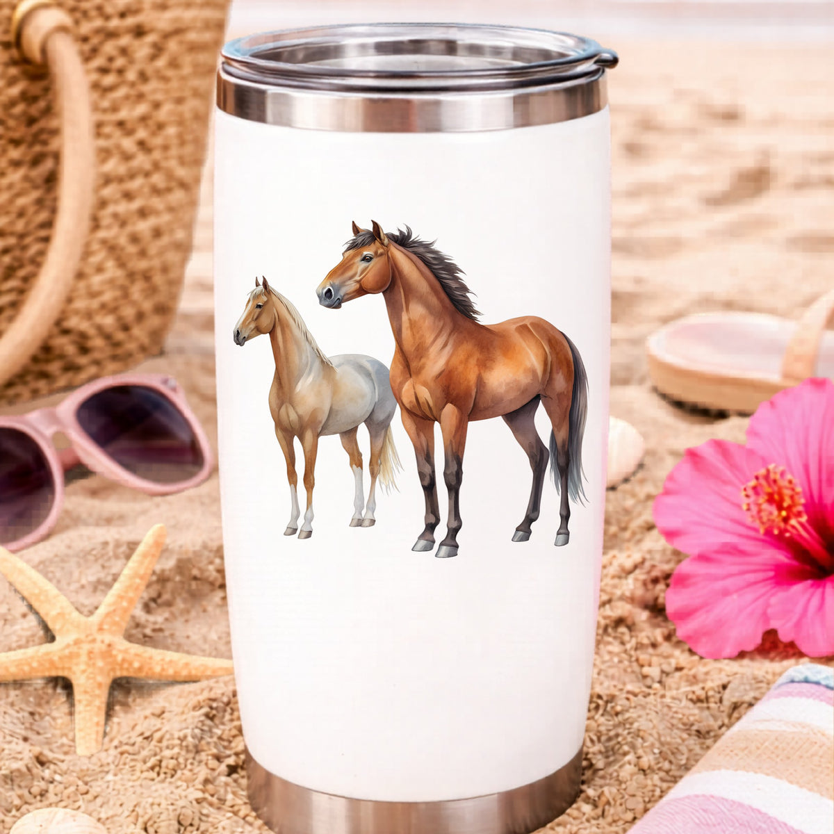 Pair Of Standing Horses Bay And Chestnut UV DTF sticker applied to a white travel tumbler on beach sand
