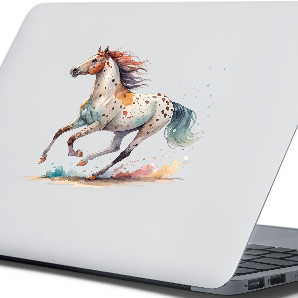 Appaloosa Spotted Horse Running UV DTF sticker applied to the lid of a silver laptop