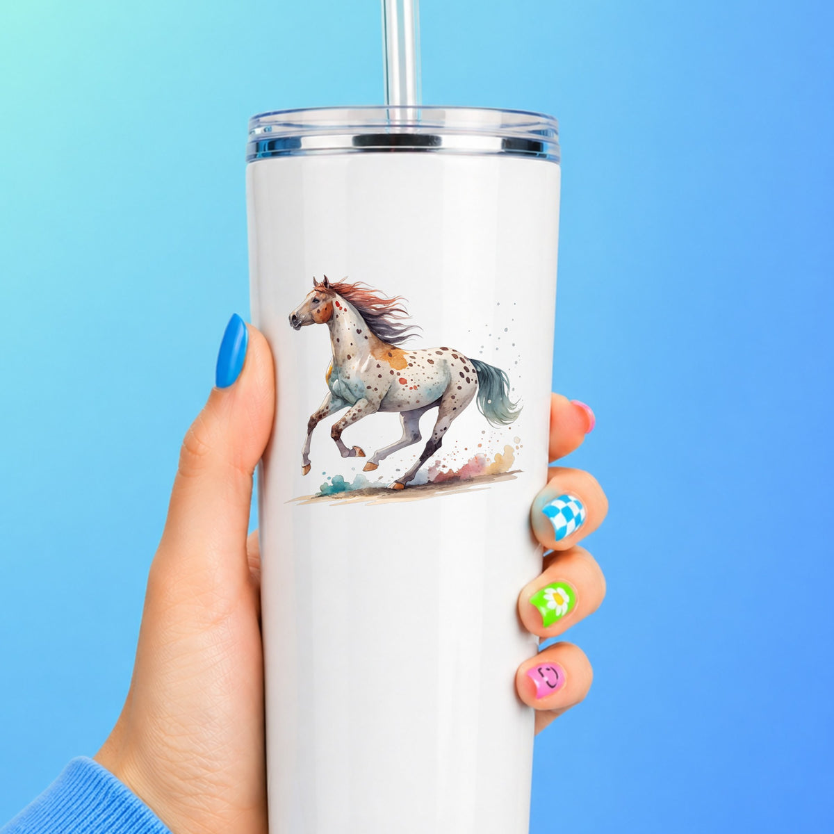 Appaloosa Spotted Horse Running UV DTF sticker applied to a white straw tumbler on a blue background