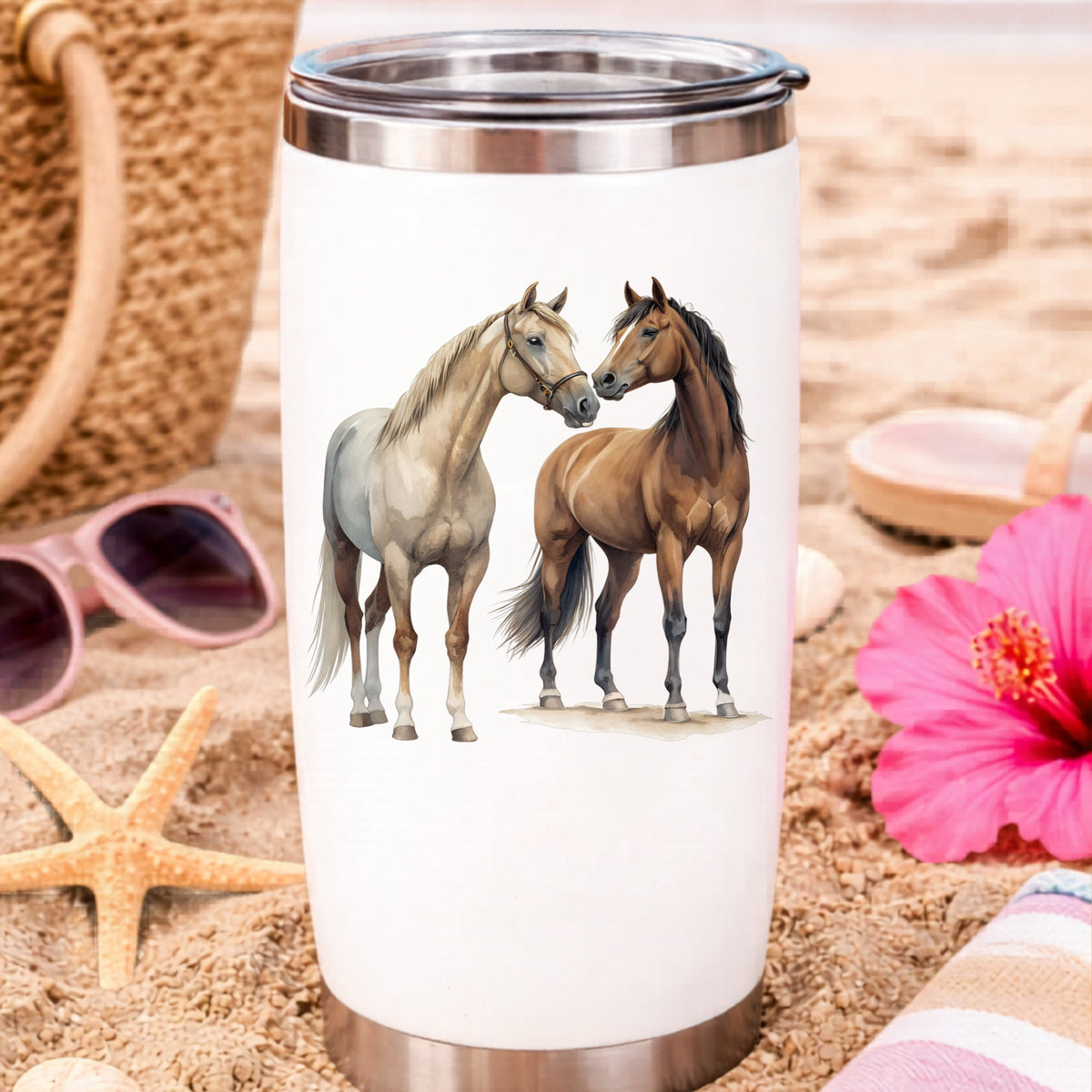 Two Horses Touching Noses UV DTF sticker applied to a white travel tumbler on beach sand