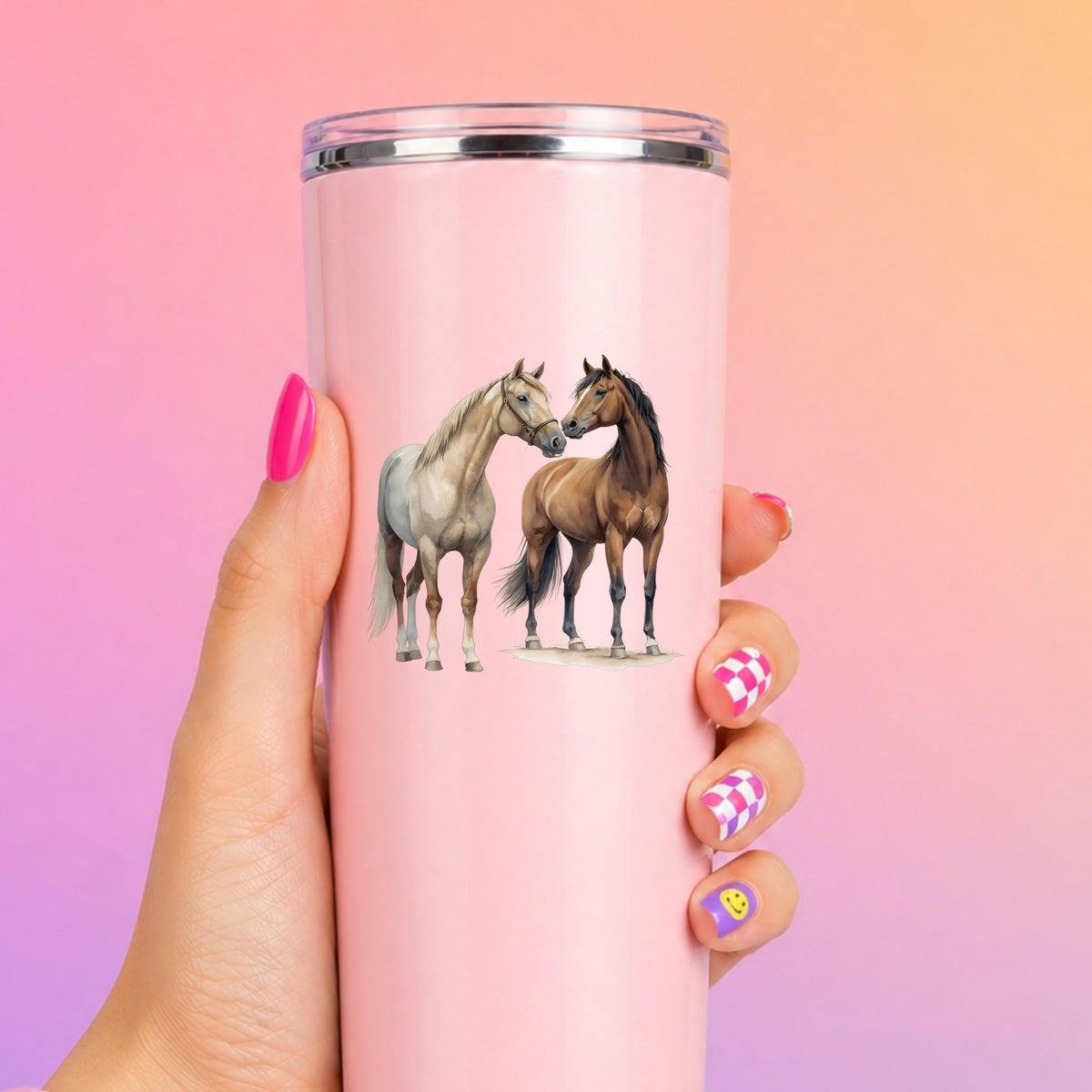 Two Horses Touching Noses UV DTF sticker applied to a tall pink tumbler on a pink and orange background