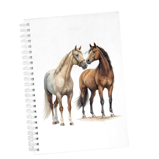Two Horses Touching Noses UV DTF sticker applied to the cover of a white spiral journal