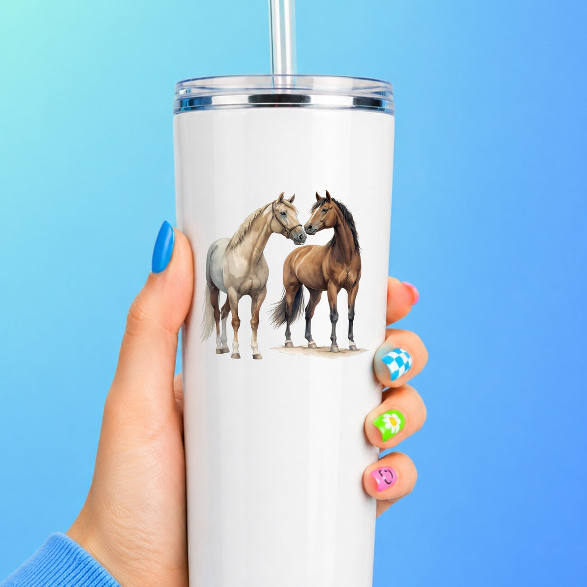 Two Horses Touching Noses UV DTF sticker applied to a white straw tumbler on a blue background