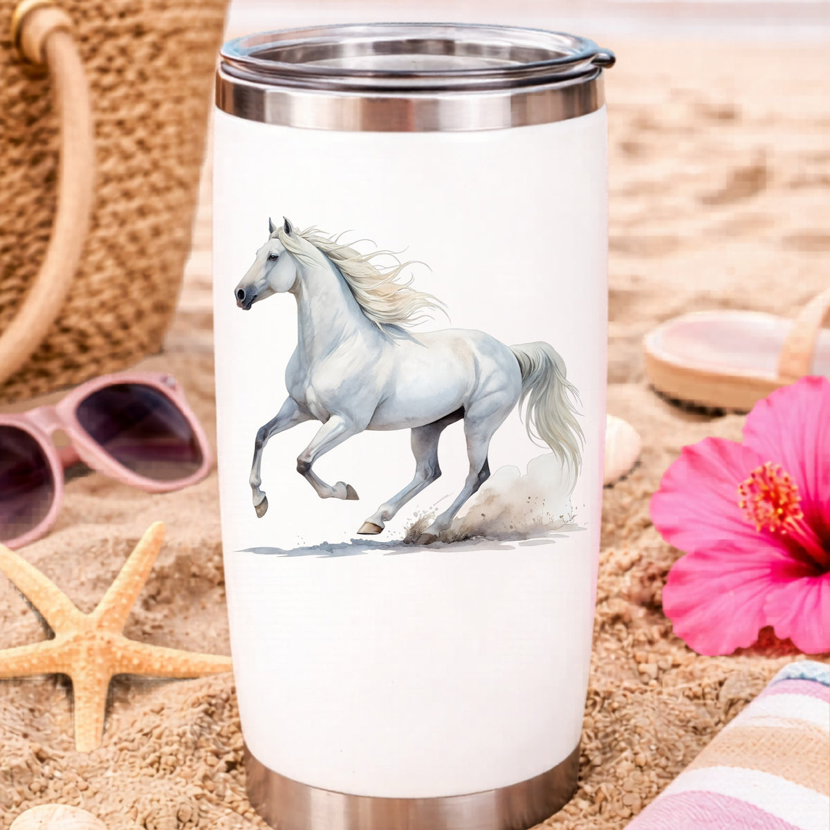 White Horse Galloping UV DTF sticker applied to a white travel tumbler on beach sand