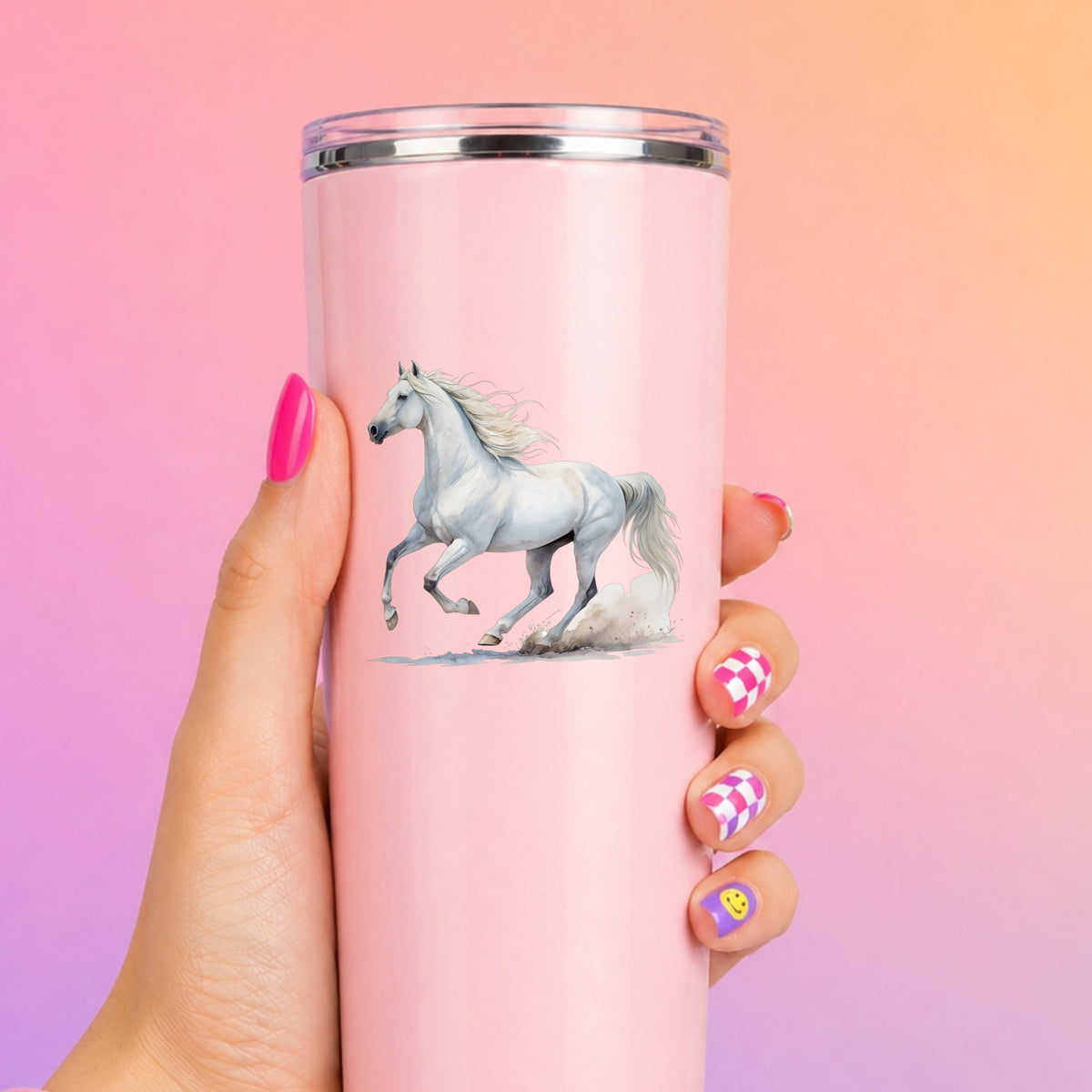 White Horse Galloping UV DTF sticker applied to a tall pink tumbler on a pink and orange background