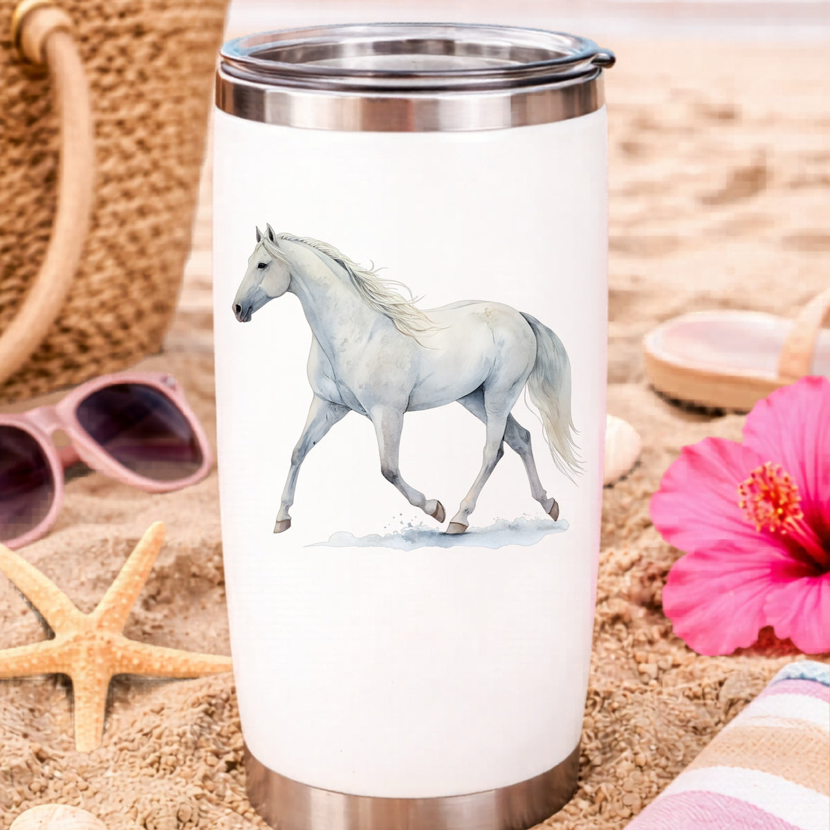 White Horse Walking UV DTF sticker applied to a white travel tumbler on beach sand