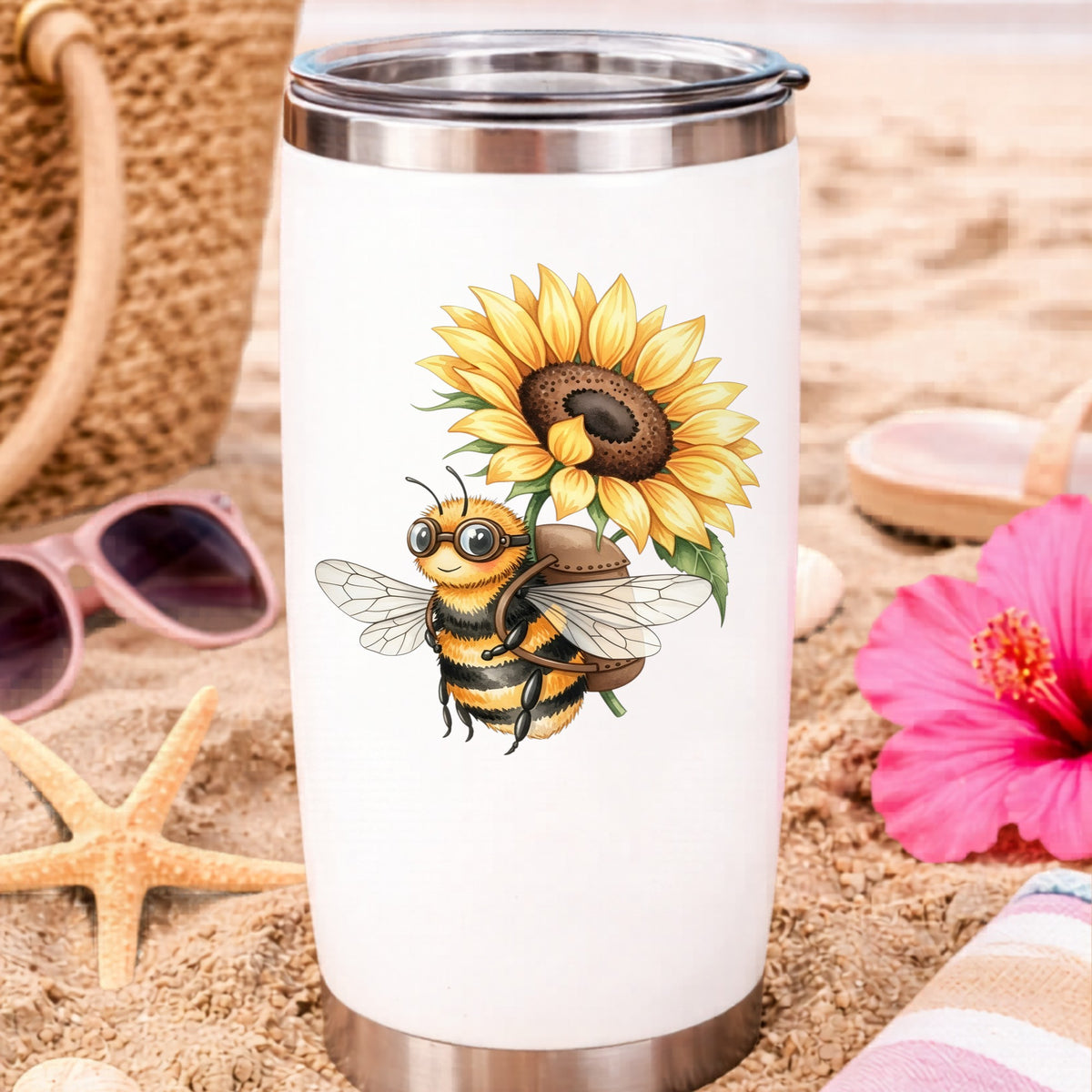 Bee Carrying Sunflower UV DTF sticker applied to a white travel tumbler on beach sand