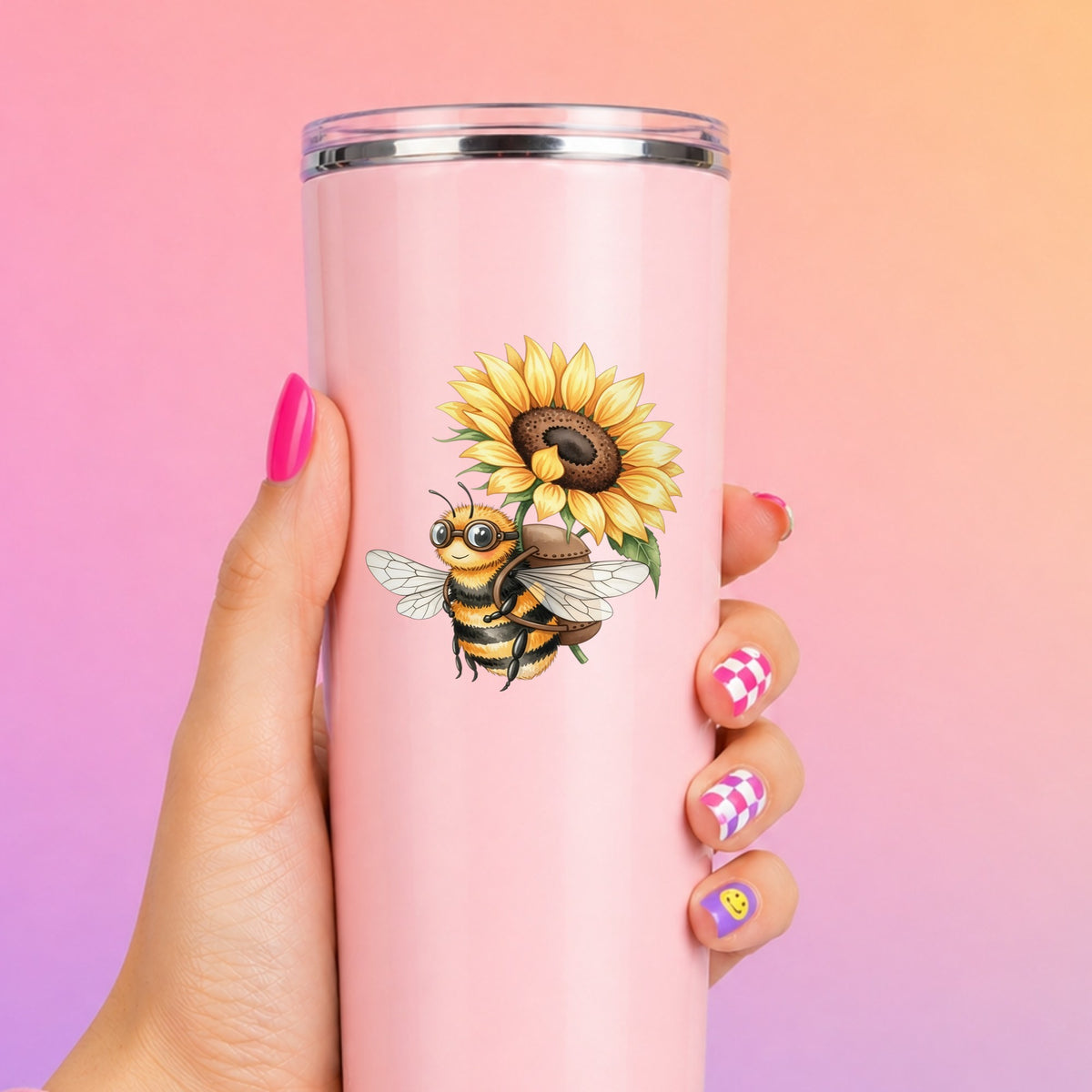 Bee Carrying Sunflower UV DTF sticker applied to a tall pink tumbler on a pink and orange background