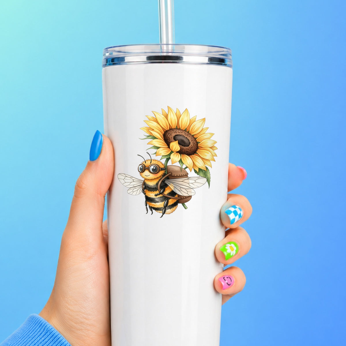 Bee Carrying Sunflower UV DTF sticker applied to a white straw tumbler on a blue background