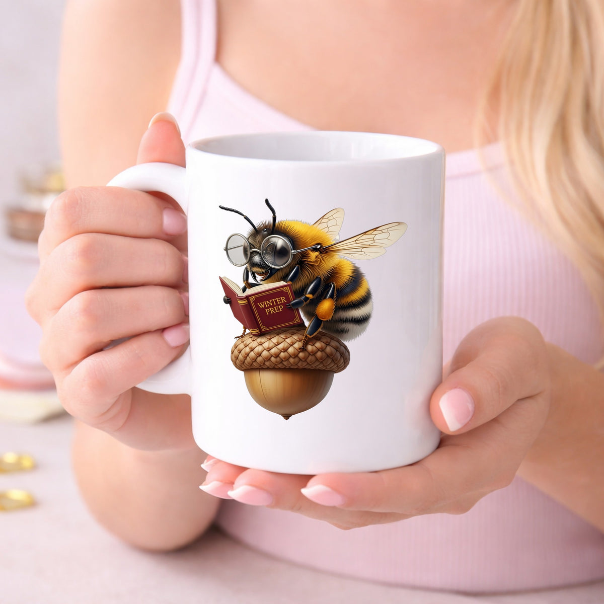 Bee Reading Book On Acorn UV DTF sticker applied to a white coffee mug held in both hands