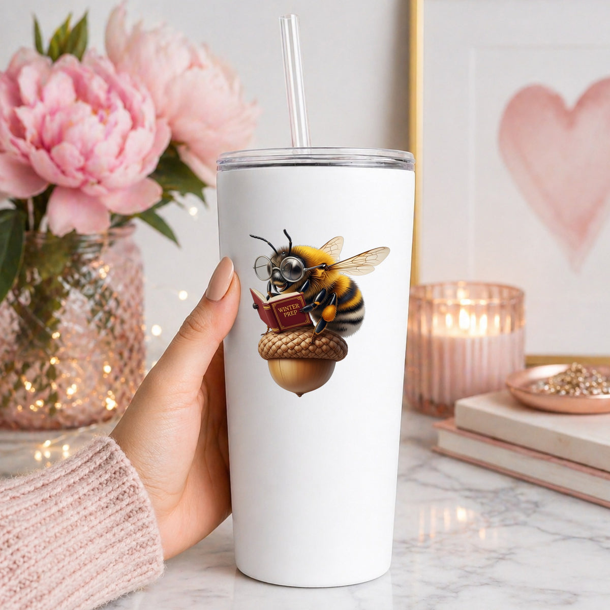 Bee Reading Book On Acorn UV DTF sticker applied to a white straw tumbler beside pink peonies