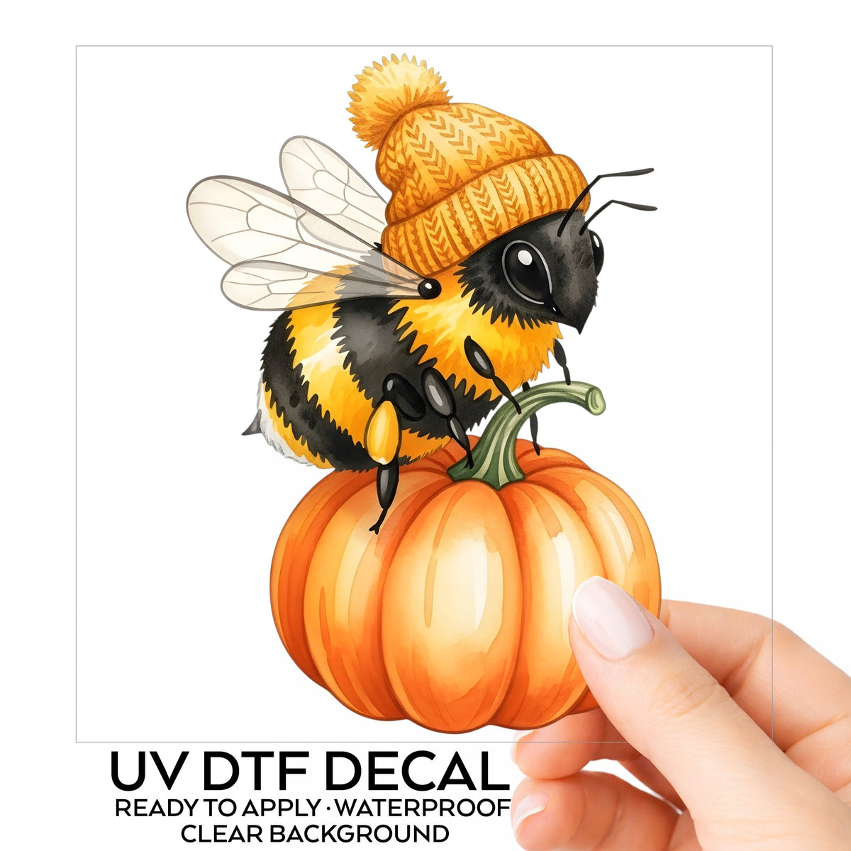 Bee In Orange Beanie On Pumpkin UV DTF sticker on its backing card, held in hand