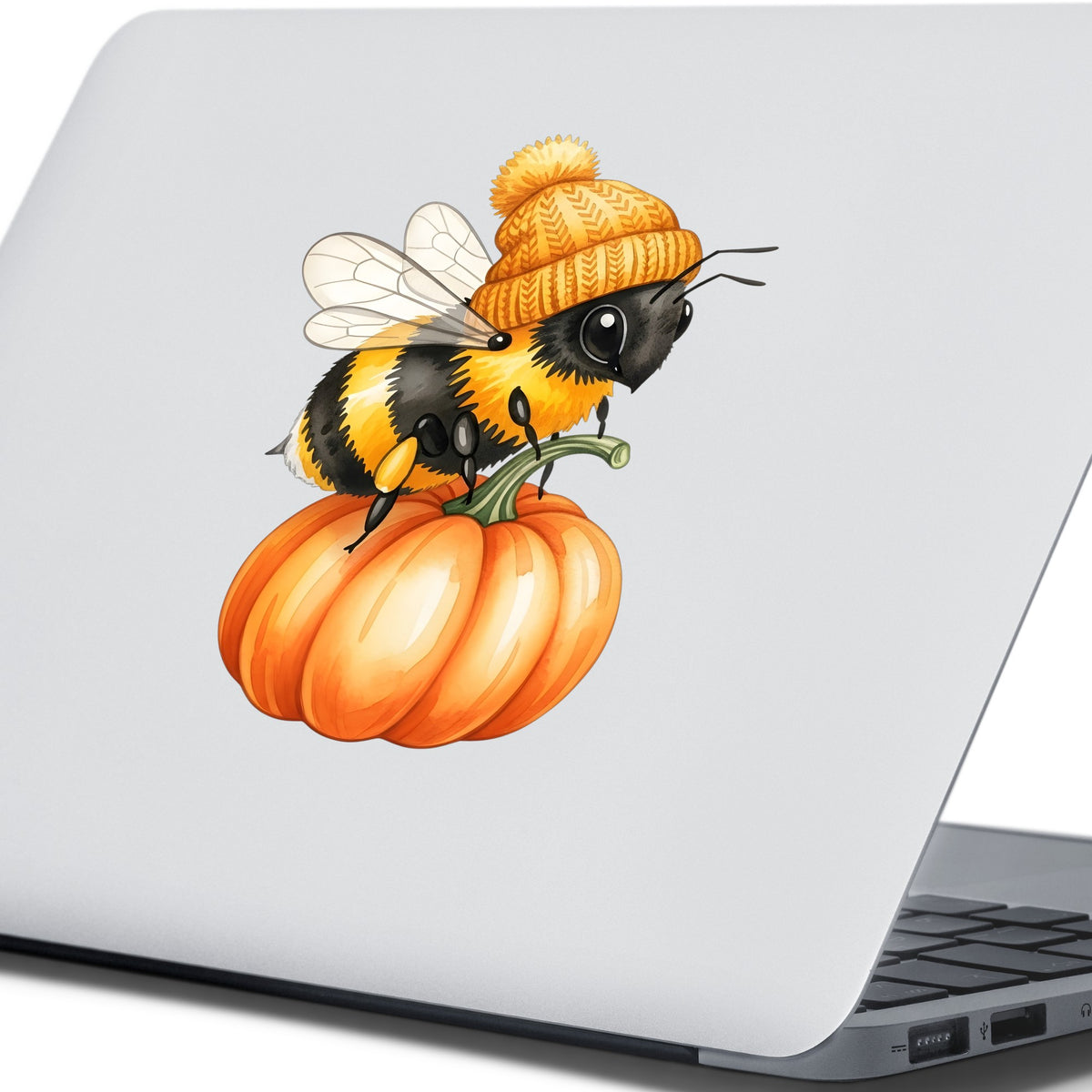Bee In Orange Beanie On Pumpkin UV DTF sticker applied to the lid of a silver laptop