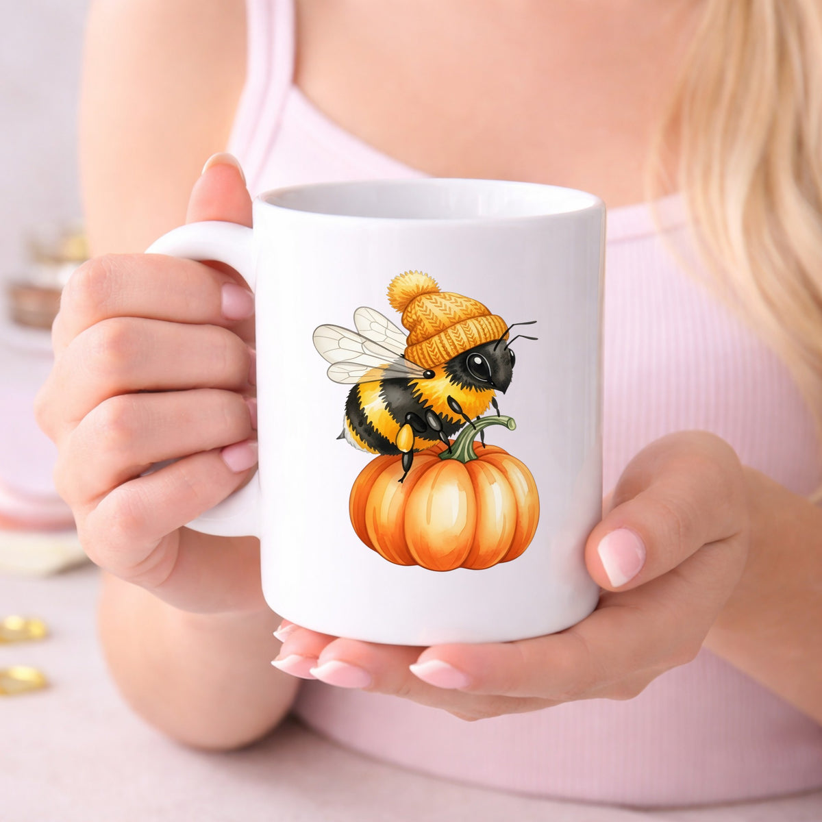 Bee In Orange Beanie On Pumpkin UV DTF sticker applied to a white coffee mug held in both hands