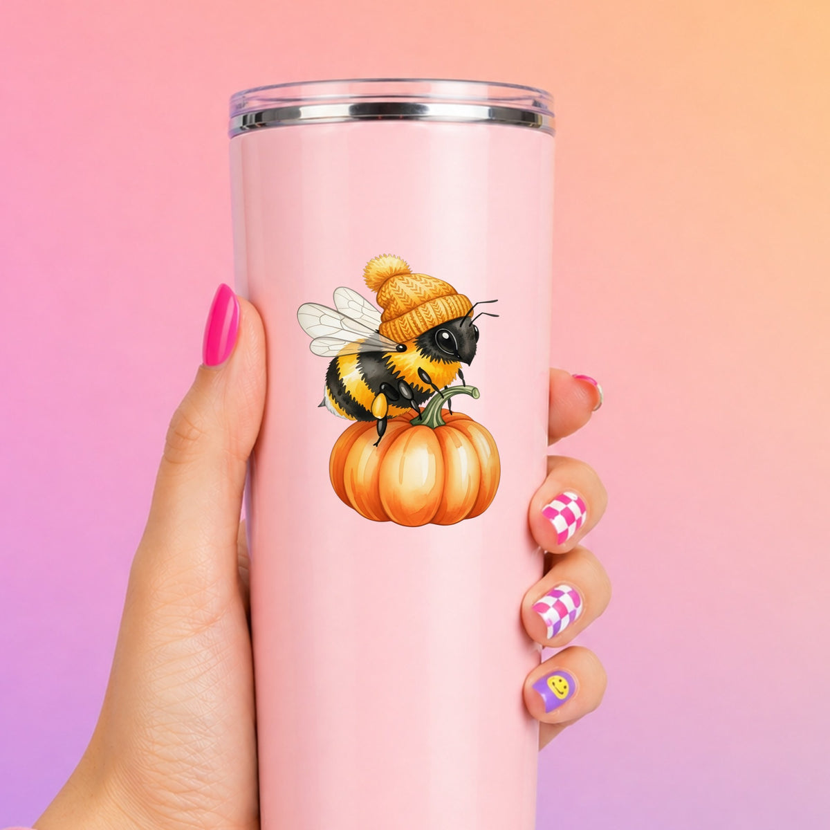 Bee In Orange Beanie On Pumpkin UV DTF sticker applied to a tall pink tumbler on a pink and orange background