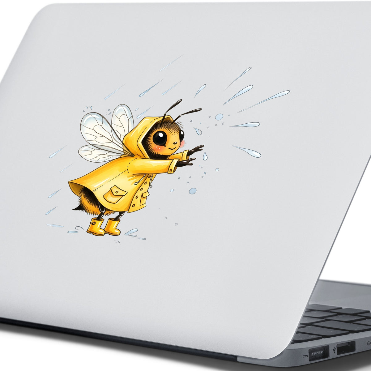 Bee In Yellow Raincoat UV DTF sticker applied to the lid of a silver laptop