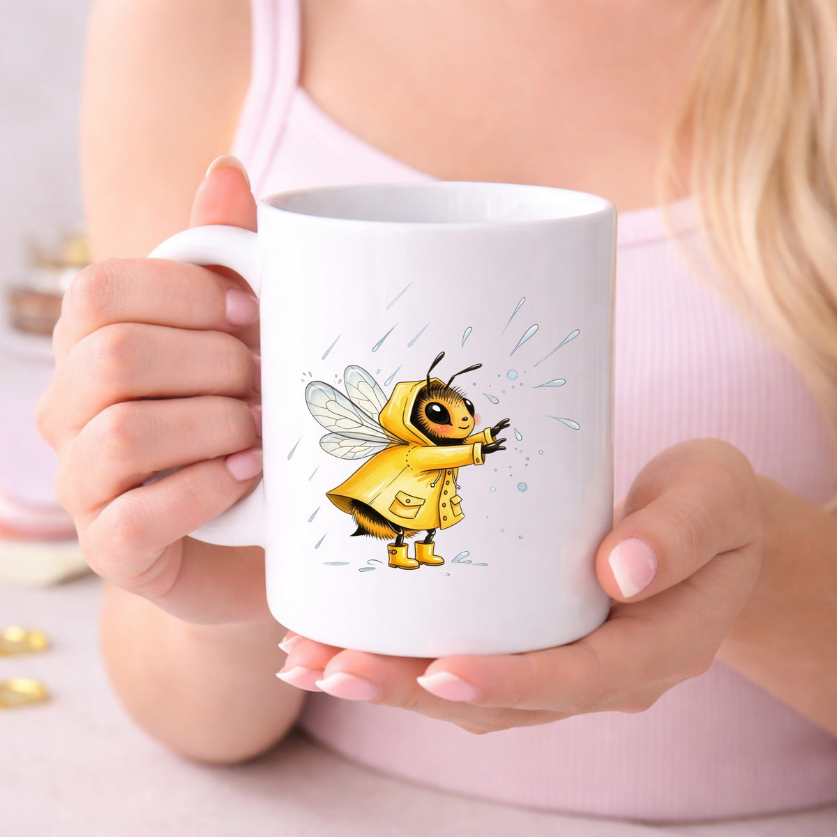Bee In Yellow Raincoat UV DTF sticker applied to a white coffee mug held in both hands