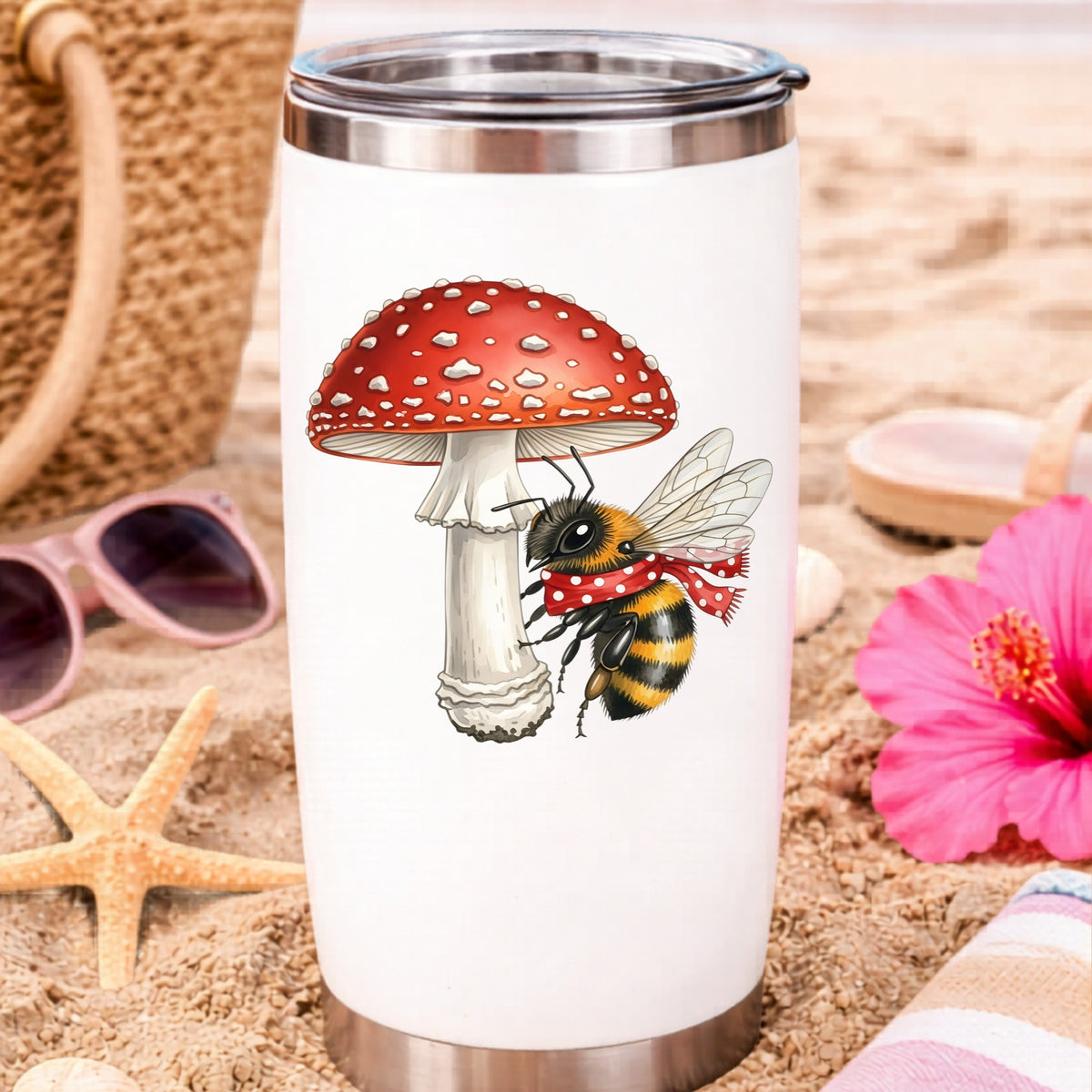 Bee With Red Mushroom UV DTF sticker applied to a white travel tumbler on beach sand