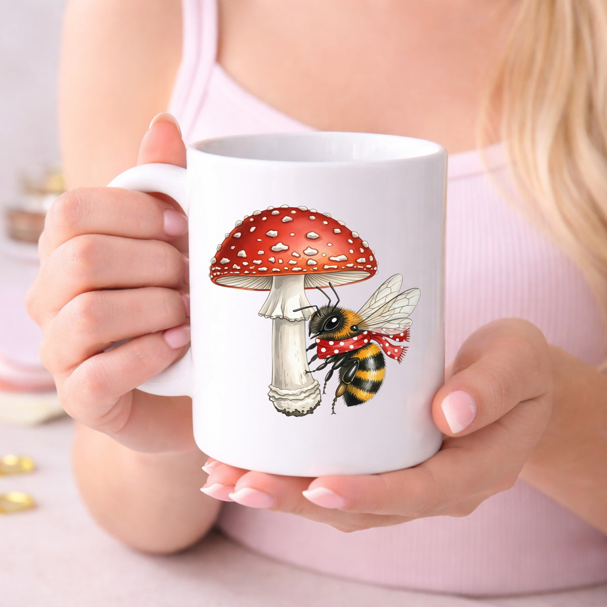 Bee With Red Mushroom UV DTF sticker applied to a white coffee mug held in both hands