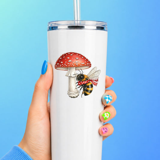 Bee With Red Mushroom UV DTF sticker applied to a white straw tumbler on a blue background