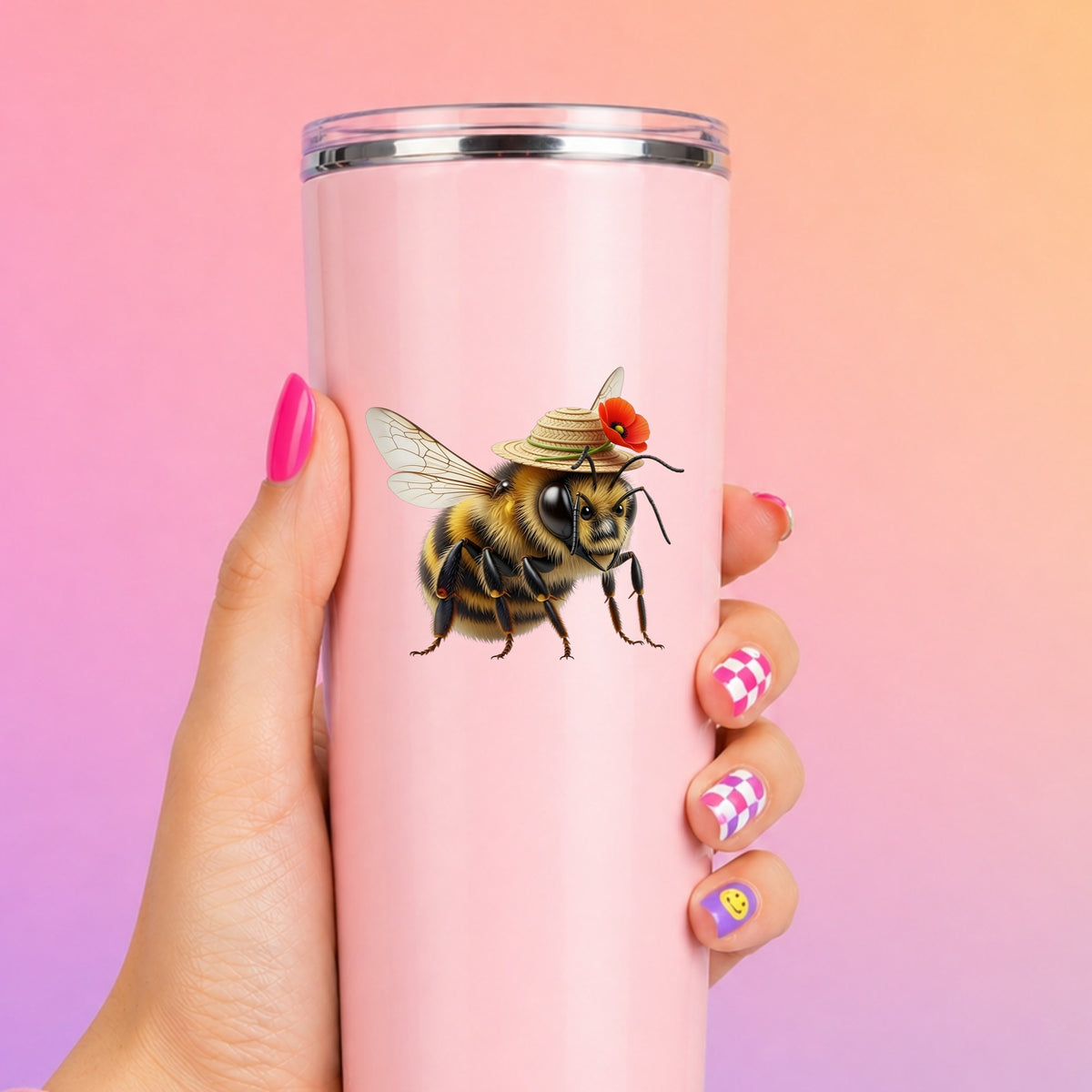 Bee In Straw Hat With Red Poppy UV DTF sticker applied to a tall pink tumbler on a pink and orange background