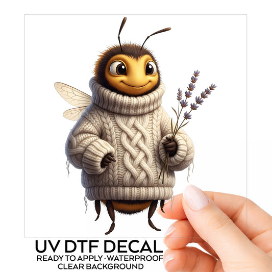 Bee In Cable Knit Sweater With Lavender UV DTF sticker on its backing card, held in hand