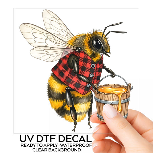 Bee In Plaid Vest With Honey Bucket UV DTF sticker on its backing card, held in hand