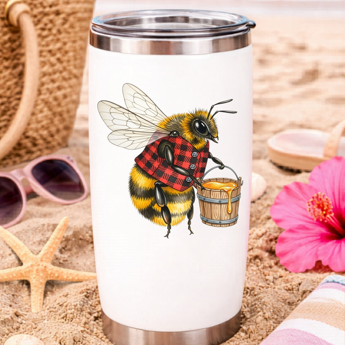 Bee In Plaid Vest With Honey Bucket UV DTF sticker applied to a white travel tumbler on beach sand