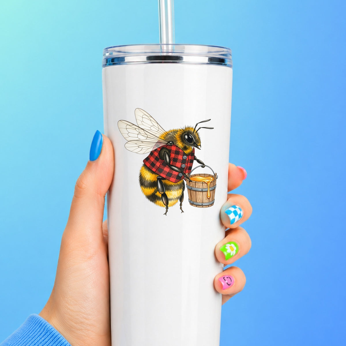 Bee In Plaid Vest With Honey Bucket UV DTF sticker applied to a white straw tumbler on a blue background