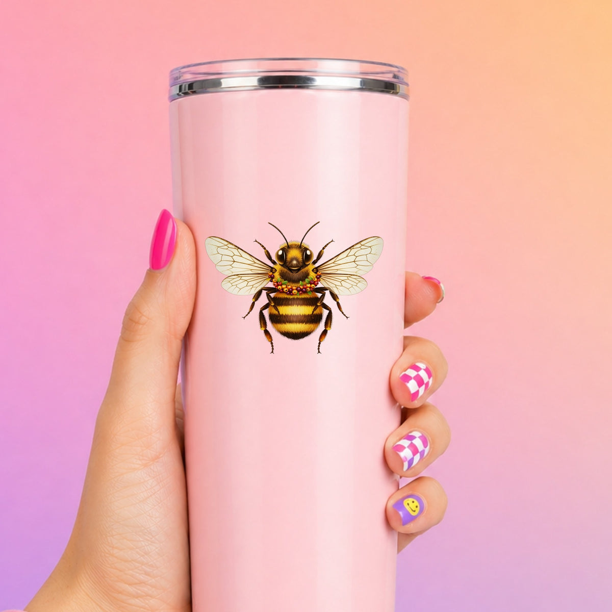 Bee With Berry Garland Necklace UV DTF sticker applied to a tall pink tumbler on a pink and orange background