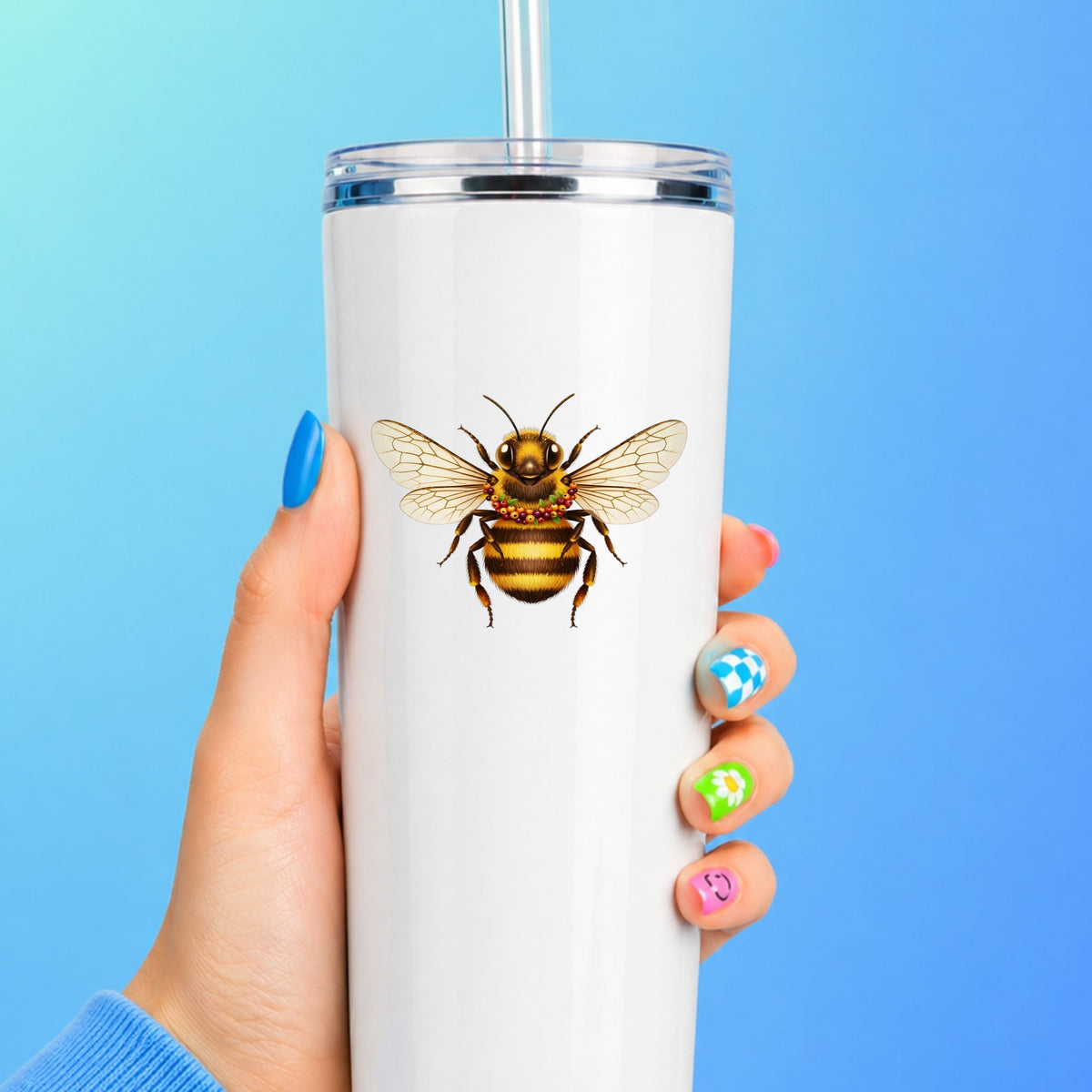 Bee With Berry Garland Necklace UV DTF sticker applied to a white straw tumbler on a blue background