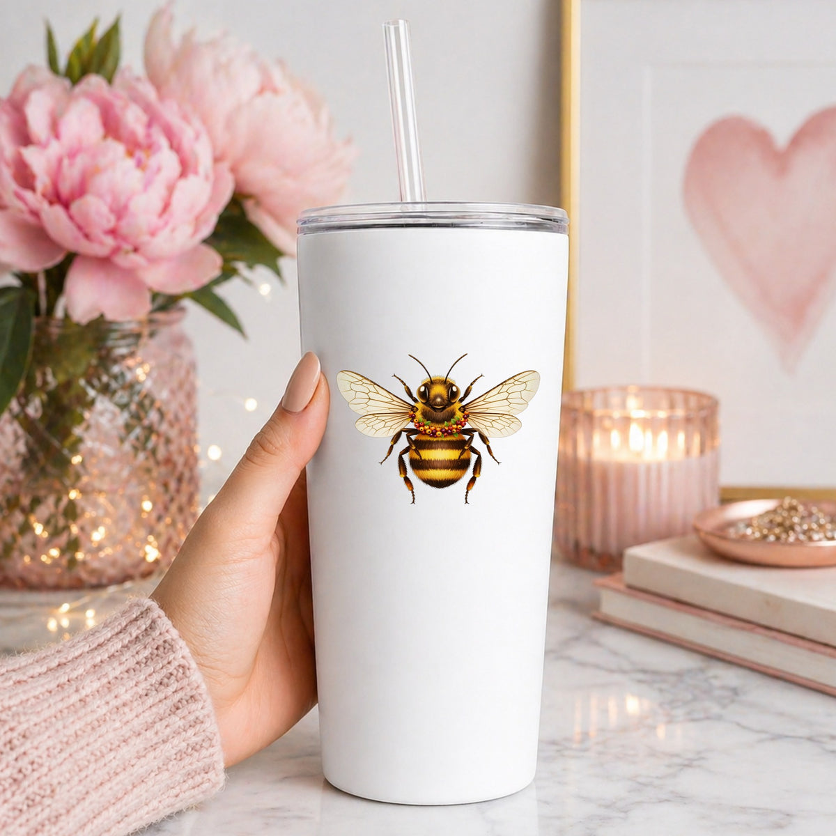 Bee With Berry Garland Necklace UV DTF sticker applied to a white straw tumbler beside pink peonies