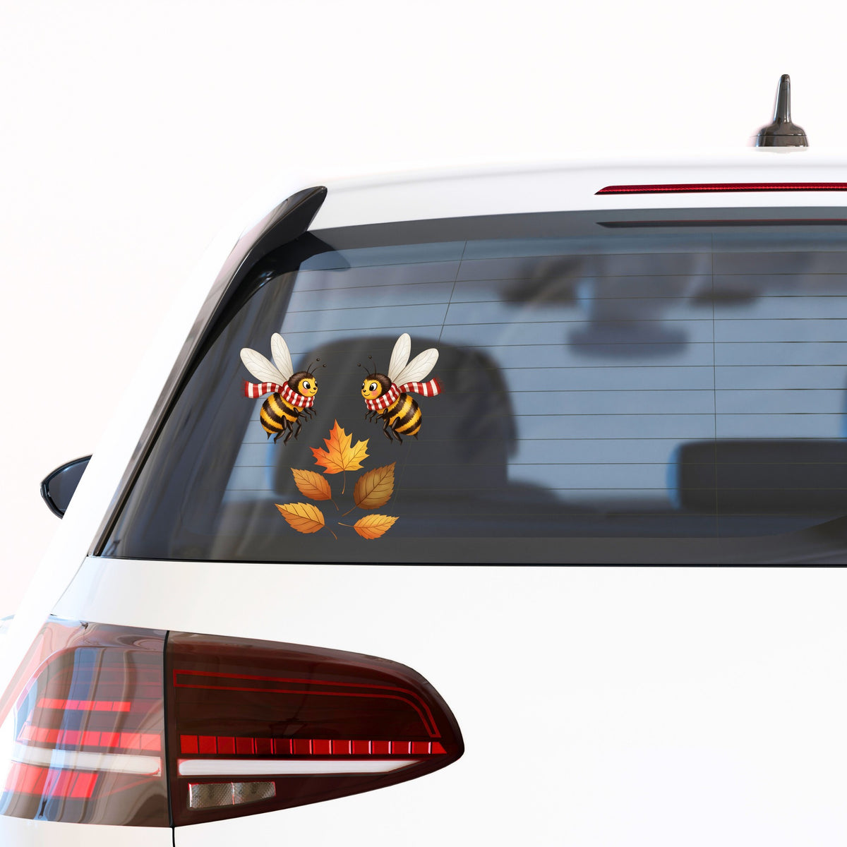 Two Bees With Autumn Leaves UV DTF sticker applied to the rear window of a white car