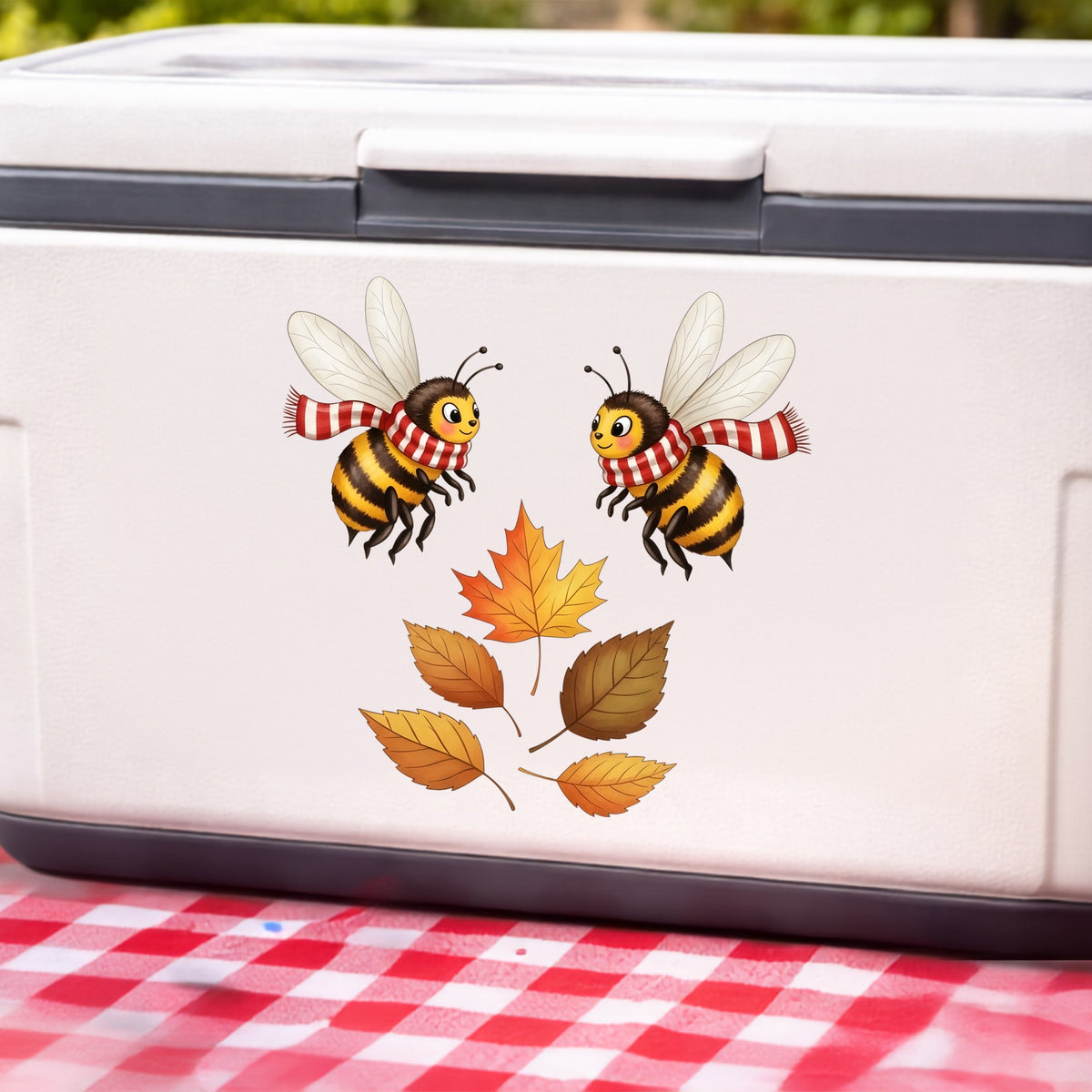 Two Bees With Autumn Leaves UV DTF sticker applied to a white cooler on a red gingham cloth