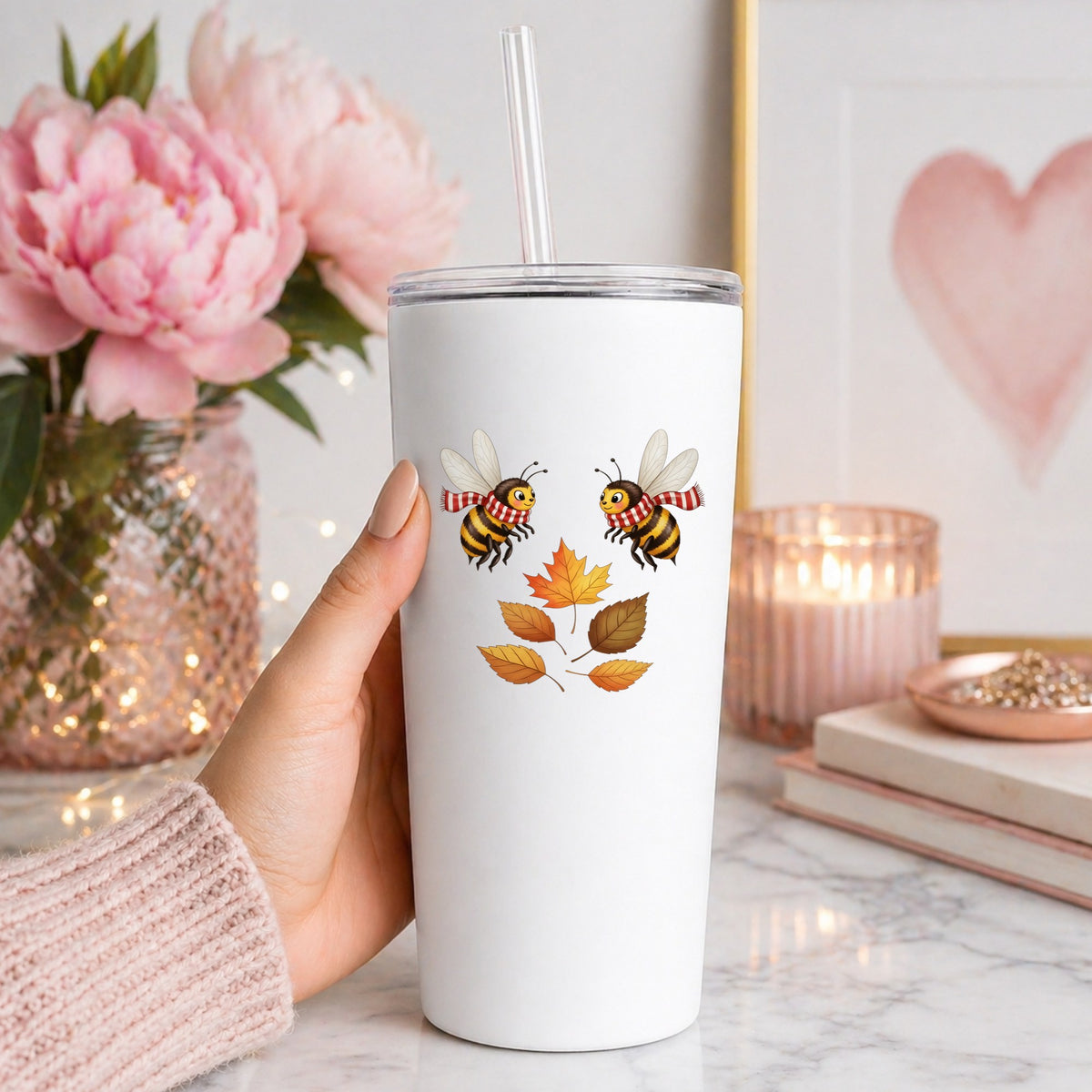 Two Bees With Autumn Leaves UV DTF sticker applied to a white straw tumbler beside pink peonies