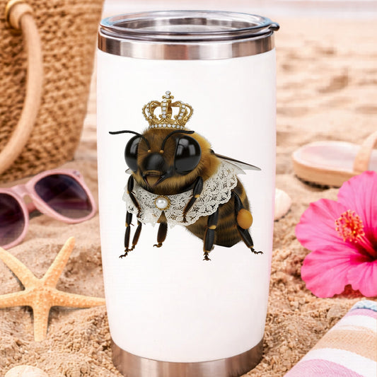 Honeybee With Gold Crown And Lace Collar UV DTF sticker applied to a white travel tumbler on beach sand