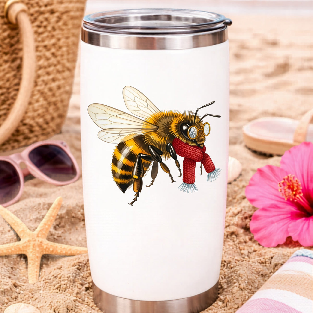 Bee With Spectacles And Red Scarf UV DTF sticker applied to a white travel tumbler on beach sand